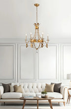 Load image into Gallery viewer, This exquisite petite chandelier features stunning hand-beaded details, candleabra bulbs, and an antique gold finish. With a dimmable light and graceful design, it is topped off with a regal touch, evocative of a crown. It's perfect for adding elegance to any room, with ornate hand-beaded accents and a shimmering antique gold finish. Enjoy the soft, adjustable lighting while appreciating the refined design.