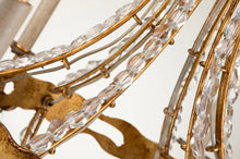 Load image into Gallery viewer, This exquisite petite chandelier features stunning hand-beaded details, candleabra bulbs, and an antique gold finish. With a dimmable light and graceful design, it is topped off with a regal touch, evocative of a crown. It's perfect for adding elegance to any room, with ornate hand-beaded accents and a shimmering antique gold finish. Enjoy the soft, adjustable lighting while appreciating the refined design.