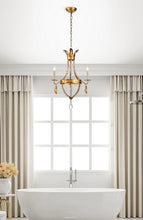 Load image into Gallery viewer, This exquisite petite chandelier features stunning hand-beaded details, candleabra bulbs, and an antique gold finish. With a dimmable light and graceful design, it is topped off with a regal touch, evocative of a crown. It's perfect for adding elegance to any room, with ornate hand-beaded accents and a shimmering antique gold finish. Enjoy the soft, adjustable lighting while appreciating the refined design.