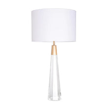 Load image into Gallery viewer, Our Monroe table lamp is a combination of simplicity and timelessness, featuring a clear crystal column paired with brushed brass accents. It's the perfect addition to any transitional, modern, or traditional interior. The faceted base and white linen circular drum shade create a balanced look, while the clear glass adds a touch of brightness and spaciousness to any room.