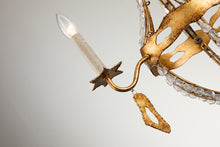 Load image into Gallery viewer, This exquisite petite chandelier features stunning hand-beaded details, candleabra bulbs, and an antique gold finish. With a dimmable light and graceful design, it is topped off with a regal touch, evocative of a crown. It's perfect for adding elegance to any room, with ornate hand-beaded accents and a shimmering antique gold finish. Enjoy the soft, adjustable lighting while appreciating the refined design.