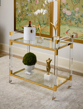 Load image into Gallery viewer, Featuring a sleek design, this bar cart boasts clear acrylic, clear tempered glass shelves, and polished brass finished iron edging. It is the perfect choice for all your essential entertaining needs.
