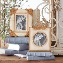 Load image into Gallery viewer, Transform your favorite photos into timeless pieces of art with the Antique Gold Photo Frames. Featuring intricate scrolling and accents of antiqued gold, these frames will add a touch of elegance to any space. The distressed cream frame adds a vintage touch, making it perfect for showcasing your cherished memories. 
