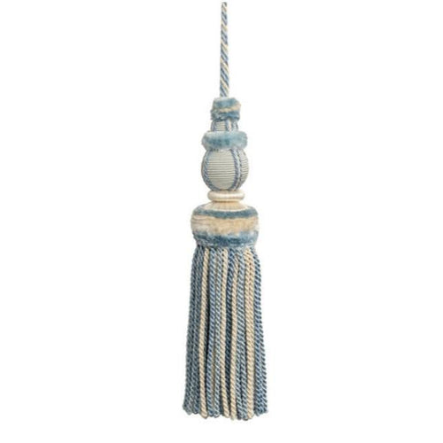 This key tassel adds a touch of history, romance, and texture with its soft hydrangea blue and cream color. Made from soft thread, it can be used to add an intriguing element to lamp pulls, cabinetry knobs, drapery, pillows, and more. Its versatile use makes it a perfect addition to any interior design. 