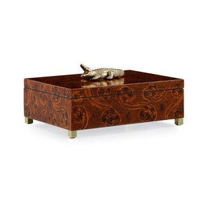 The Bayou Box features a captivating blend of natural elements and vibrant metallic colors, resulting in a truly distinctive and elegant accent piece. The swirling brown tones of the box are expertly complemented by delicate brass legs and an intricately-designed alligator on the lid.