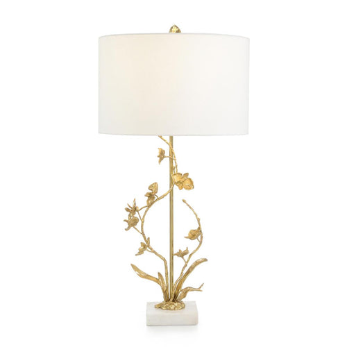 The Bree table lamp combines natural inspiration and modern design, featuring a detailed brass body with winding branches and floral embellishments. It sits on a marble base, creating a playful contrast with the organic shape of the lamp. The hammered brass finial adds the finishing touch to this captivating turnkey piece.