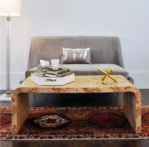 Crafted with old-world expertise, our Burl Waterfall Cocktail Table boasts a striking mid-century modern design. The elegant arc silhouette and exquisite book-matched matte burl veneer make it a unique centerpiece for a luxurious, high-style living space.