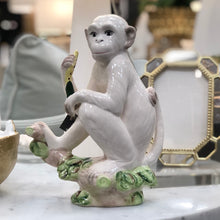 Load image into Gallery viewer, A delightful combination of whimsy and sophistication, this carefully crafted ceramic monkey adds a touch of eclectic personality to your stylish home.
