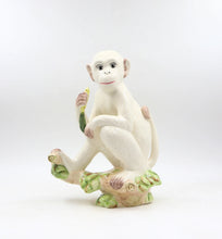 Load image into Gallery viewer, A delightful combination of whimsy and sophistication, this carefully crafted ceramic monkey adds a touch of eclectic personality to your stylish home.
