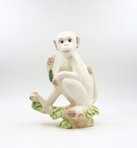 A delightful combination of whimsy and sophistication, this carefully crafted ceramic monkey adds a touch of eclectic personality to your stylish home.