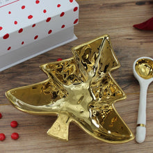 Load image into Gallery viewer, This Christmas Tree Serving Set is perfect for gifting or even as a personal treat to yourself. Packaged in a stylish magnetic closure gift box, the inside cover features a customizable sentiment. With a festive tree-shaped bowl and a white porcelain spoon with gold accents, this set is ideal for serving candies, nuts, fruit, or condiments. Made from stunning gold-tone titanium-finished porcelain, this set adds a touch of elegance to any table setting.
