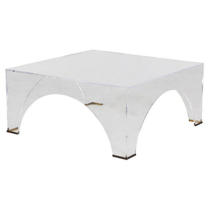 Crafted from clear acrylic, the Cindy Coffee Table boasts a sophisticated and elegant design, with a unique arched shape and brushed brass accents. Its transparency allows for an open and airy feel, complementing any space.