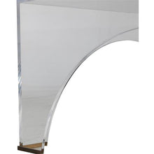 Load image into Gallery viewer, Crafted from clear acrylic, the Cindy Coffee Table boasts a sophisticated and elegant design, with a unique arched shape and brushed brass accents. Its transparency allows for an open and airy feel, complementing any space.
