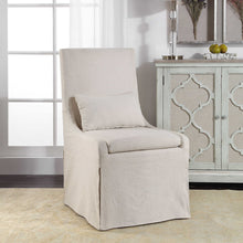 Load image into Gallery viewer, Crafted with simplicity in mind, this refined armless dining chair boasts a fitted slipcover in a neutral off-white linen blend. Its seat is cushioned for ultimate comfort and comes with an accompanying kidney pillow. The added performance treatment also makes it resistant to stains and soiling, ensuring long-lasting use.
