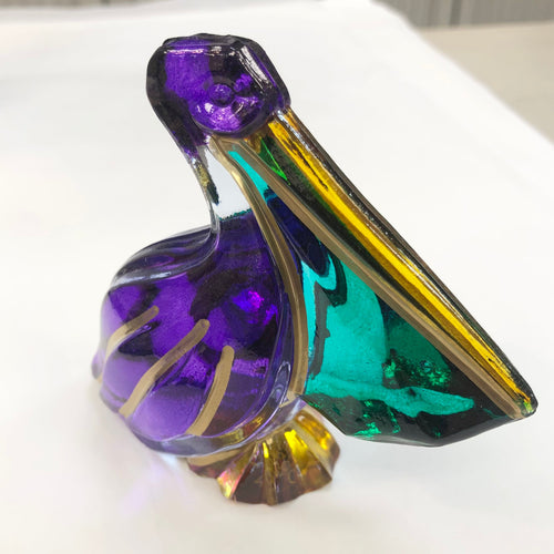 Hand-painted venetian crystal pelican, in traditional Mardi Gras colors of purple, green and gold.