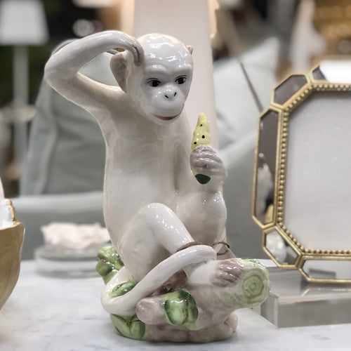 A delightful combination of whimsy and sophistication, this carefully crafted ceramic monkey adds a touch of eclectic personality to your stylish home.