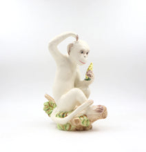 Load image into Gallery viewer, A delightful combination of whimsy and sophistication, this carefully crafted ceramic monkey adds a touch of eclectic personality to your stylish home.
