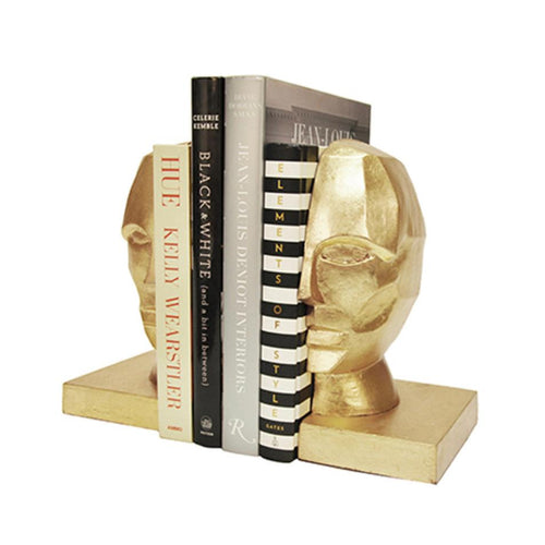 Enhance the style of your shelves with our Face to Face Golden Bookends. These bookends feature a captivating, expertly crafted gold leaf facial profile, making them a must-have addition to any display. As funky and unique home decor, they will add a touch of allure while keeping your books organized.