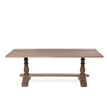 Load image into Gallery viewer, The elegant Giselle pine table comfortably accommodates 8 people. Its sturdy construction features a classic trestle and baluster base, reminiscent of a 17th-century banquet table, making it the perfect setting for hosting friends and family for a grand meal.
