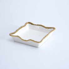 Load image into Gallery viewer, Enhance the visual appeal and sophistication of your dining area with this stunning luncheon napkin holder. Doubles as servingware to present delectable pastries and fresh fruit. Made of high-quality white porcelain with shimmering gold beads made of titanium.
