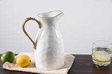 Load image into Gallery viewer, This elegant pitcher serves as both a stylish centerpiece and a practical vessel for drinks. It exudes sophistication with its gleaming white high-fired porcelain and stunning gold titanium rim and handle, making it the perfect balance between formal and hospitable.
