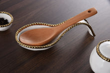 Load image into Gallery viewer, Effortlessly stylish and functional, the Golden Beaded Spoon Rest is a must-have for any dinner party. Keep your serving utensils neat and tidy while impressing your guests with this stunning and practical accessory. Perfect for buffets and maintaining a clean kitchen, this spoon rest is an essential addition to your table setting. Made of high-quality white porcelain with shimmering gold beads made of titanium.
