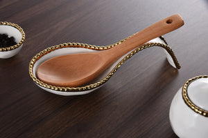 Effortlessly stylish and functional, the Golden Beaded Spoon Rest is a must-have for any dinner party. Keep your serving utensils neat and tidy while impressing your guests with this stunning and practical accessory. Perfect for buffets and maintaining a clean kitchen, this spoon rest is an essential addition to your table setting. Made of high-quality white porcelain with shimmering gold beads made of titanium.