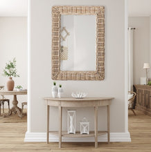 Load image into Gallery viewer, This stunning mirror is tailored for open concept spaces. Designed with a large gauge woven rattan frame, it exudes sophistication. Whether displayed horizontally or vertically, it is a magnificent addition to any bedroom, entryway, or foyer.
