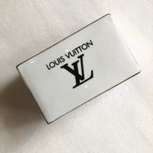 Load image into Gallery viewer, Impress your connections with this ceramic notecard box adorned with a chic fashion insignia. Accompanied by a set of matching notecards, this set is the epitome of tasteful luxury and elegance. It&#39;s the perfect way to leave a lasting impression with your personal touch.
