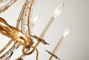 This exquisite petite chandelier features stunning hand-beaded details, candleabra bulbs, and an antique gold finish. With a dimmable light and graceful design, it is topped off with a regal touch, evocative of a crown. It's perfect for adding elegance to any room, with ornate hand-beaded accents and a shimmering antique gold finish. Enjoy the soft, adjustable lighting while appreciating the refined design.