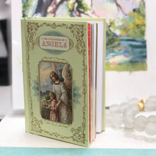 Load image into Gallery viewer, Discover the divine messages, faithful guardians, and mystical celestial beings of the angelic world within the pages of The Little Book of Angels. This exquisite tome features stunning color lithographs from missals and prayer books, elegantly packaged with a padded cover, gilded edges, and a ribbon marker. Whether as a gift for a religious or spiritual occasion or for those seeking guidance from angelic beings, this book exudes elegance and beauty.
