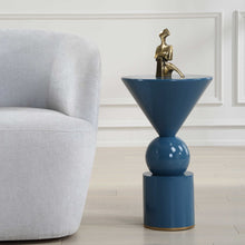 Load image into Gallery viewer, This Luster Blu Accent Table features a sleek blue finish and modern geometric shapes, making it a stylish addition to any space. Its painted gold base provides both durability and a touch of metallic shine.
