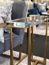 Load image into Gallery viewer, Experience true luxury with the exquisite Midas Accent Table. Crafted with textured antique gold finish iron legs, this table expertly supports a thick crystal top for an elegant touch to any room.
