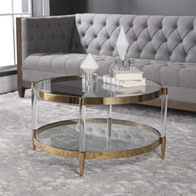 Load image into Gallery viewer, The Monroe Coffee Table is a glamorous addition to any space. It boasts a gold plated stainless steel frame, paired with clear glass and acrylic legs, complete with tapered feet for added elegance.
