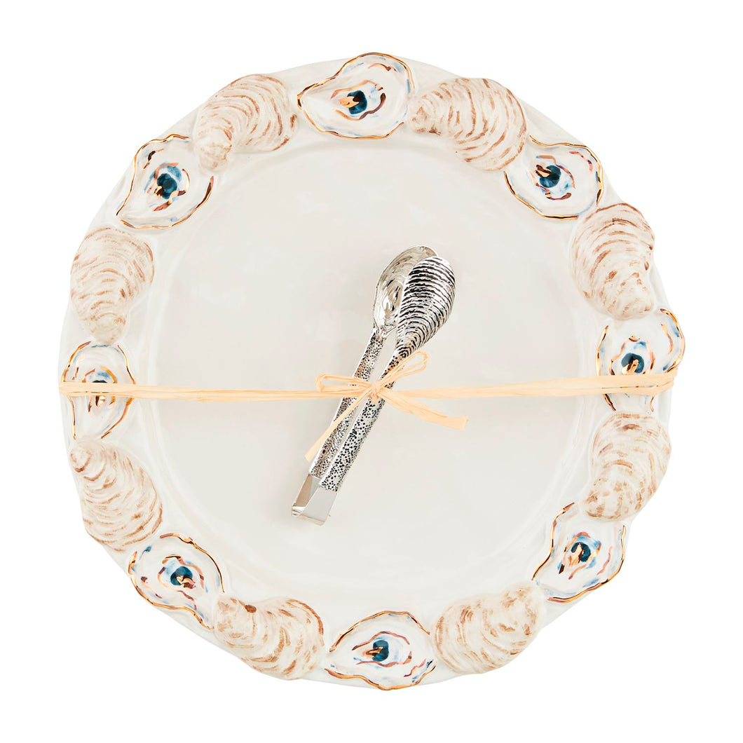 Add a touch of glamour to your next seafood soirée with this stoneware platter set that includes stainless steel oyster tongs. Each platter features a layered stoneware oyster shell rim accented with gilding that adds a unique and playful touch to your presentation. Get ready to shuck and serve in style!