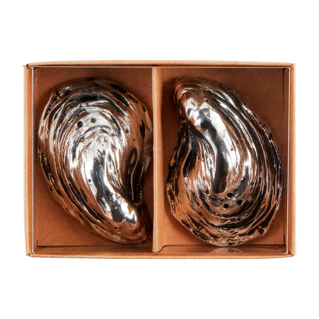 Add a touch of summer whimsy to your dining table with these oyster-shaped salt and pepper shakers. Made of durable and stylish cast aluminum, they're sure to be the talk of your next dinner party.