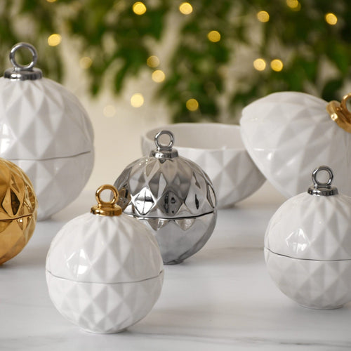 Great for serving candies, nuts, fruit, or condiments! A festive ornament shaped bowl in stunning and elegant white and gold metallic finished high-fired porcelain. Ideal for serving a variety of treats such as candies, nuts, fruits, or condiments. Made from high-fired porcelain, this stunning and elegant white and gold metallic ornament bowl is a festive addition to any table setting.