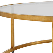 Load image into Gallery viewer, The Radius Coffee Table is an ideal addition to contemporary settings, showcasing a durable iron frame with a subtle antique gold finish. Its sleek, clear glass tabletop adds a touch of elegance to any room.
