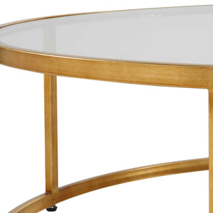 The Radius Coffee Table is an ideal addition to contemporary settings, showcasing a durable iron frame with a subtle antique gold finish. Its sleek, clear glass tabletop adds a touch of elegance to any room.