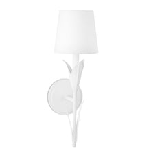 Load image into Gallery viewer, The River Reed Single Sconce features a botanical design and elegant white finish, making it perfect for traditional spaces. Its reeded arm gracefully extends upwards to support a delicate natural linen shade, while sitting on a round plate.
