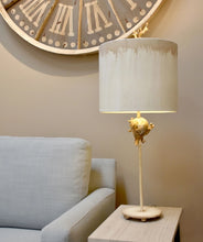 Load image into Gallery viewer, The Trellis table lamp is adorned with organic elements and a sculpted branch finial, adding a touch of elegance to the mix of silver and gold.
