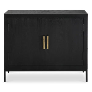 Perfect for any space with its sleek design and timeless finishes. The dark ebony oak veneer is accented by aged gold linear iron pulls. Includes one fixed shelf inside.