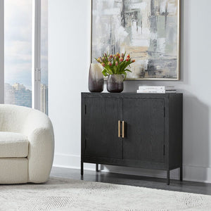 Perfect for any space with its sleek design and timeless finishes. The dark ebony oak veneer is accented by aged gold linear iron pulls. Includes one fixed shelf inside.
