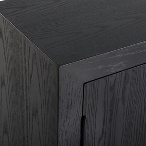 Perfect for any space with its sleek design and timeless finishes. The dark ebony oak veneer is accented by aged gold linear iron pulls. Includes one fixed shelf inside.