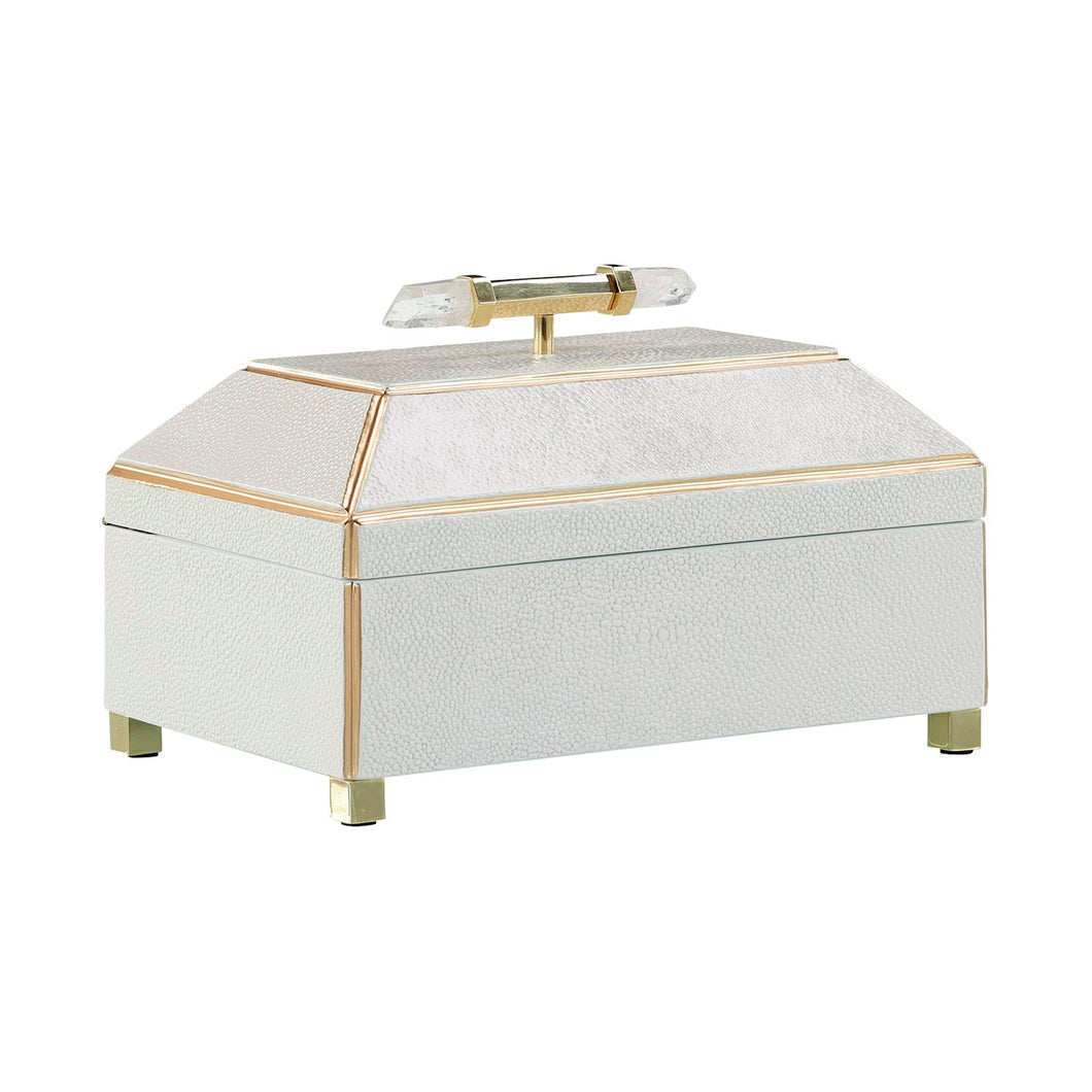 This luxurious container boasts a refined faceted design and exquisite cream white color, highlighted by gold accent trim and supporting legs. The top is adorned with two stunning clear crystals, attached to a brass fixture for a polished look.