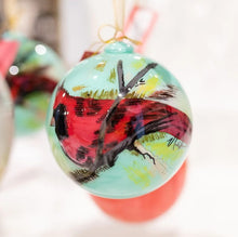 Load image into Gallery viewer, Elevate your holiday decor with Anne Neilson&#39;s exclusive, limited edition Christmas ornaments. Each one is meticulously hand-painted from an original Anne Neilson artwork, making them a unique fusion of art and festive spirit. Share these treasured ornaments with loved ones or keep them as luxurious keepsakes. Ornament is a 3&quot; glass ball with gold ribbon.
