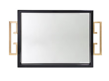 Load image into Gallery viewer, The Avana Tray features a high gloss lacquer finish in black or white, accompanied by a beveled mirror inset and gold leaf iron handles on the sides, making it both decorative and functional.
