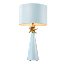 Load image into Gallery viewer, The Anemone Table Lamp features a unique design with its elegant tapered silhouette and distinctive anemone accent. The painted card cylinder shade pairs perfectly to add a touch of elegance to any room.
