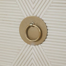 Load image into Gallery viewer, Close-up of door pull on contemporary ribbed-front cabinet in a white cerused finish with champagne hardware accents.
