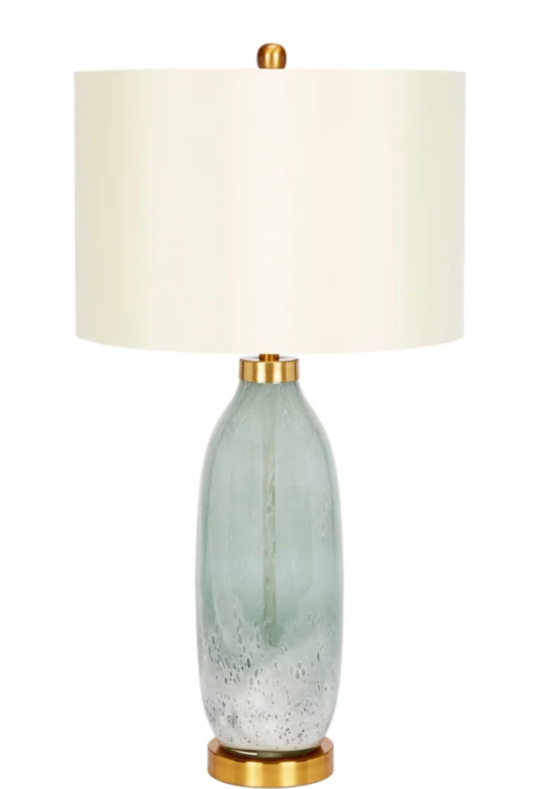 The Carley Lamp showcases a beautiful green hue, complemented by refined gold accents. The artistry of hand blown glass is the focal point of this accent lamp, bringing a touch of vibrant color and cozy warmth to any space in your home.